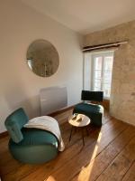 a living room with a couch and a table and a mirror at Le Clos des Grands Frênes in Pons