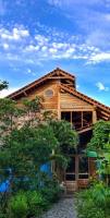 una casa de madera con techo abuhardillado en Oro Beach Houses, en Weetebula