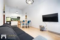 Televízia a/alebo spoločenská miestnosť v ubytovaní Loft Morski by LookAp