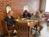 a group of people sitting at a table eating food at Madhuban Hotel in Kathmandu