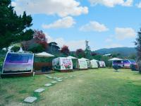 a row of tents parked in a field at 見晴花園山莊Sunshine Villa in Ren&#39;ai