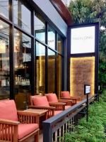 una fila de bancos frente a un restaurante en The Bedrooms Maeklong and Services Apartment, en Samut Songkhram