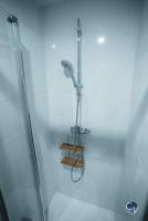 a shower in a bathroom with a glass door at Appartement neuf et moderne dans le centre ville in Bagnols-sur-Cèze