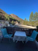 a table and chairs sitting on a patio with a mountain at T2 au cœur de la nature de Digne in Digne-les-Bains