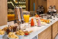 a buffet line with breakfast foods and drinks at One Sixteen Hotel in Bogotá