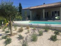 a villa with a swimming pool in front of a house at Villa Emma 10 &#47; 12 personnes in Grignan