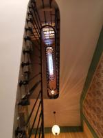 a room with a spiral staircase with a light fixture at Mes à Moi in Pezenas - Studio &amp; patio privatif - O Pitchoun in Pézenas