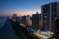 ein Blick auf eine Stadt bei Nacht mit Gebäuden in der Unterkunft SpringHill Suites by Marriott Myrtle Beach Oceanfront in Myrtle Beach