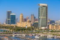 a city skyline with tall buildings and boats in the water at W Dubai - Mina Seyahi in Dubai