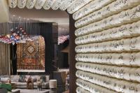 a wall filled with white plates with writing on it at W Dubai - Mina Seyahi in Dubai