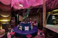 a purple room with a purple table and stools at W Dubai - Mina Seyahi in Dubai
