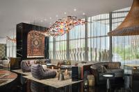 a lobby with a bar with couches and chairs at W Dubai - Mina Seyahi in Dubai