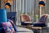 a room with chairs and a couch and a window at W Dubai - Mina Seyahi in Dubai