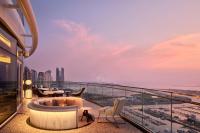 a balcony with a tub and chairs on a building at W Dubai - Mina Seyahi in Dubai