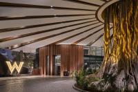 a lobby with a large tree in front of a building at W Dubai - Mina Seyahi in Dubai