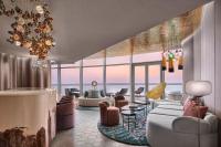 a rendering of a living room with a couch and chairs at W Dubai - Mina Seyahi in Dubai