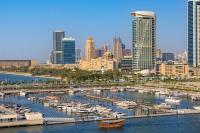 a group of boats docked at a marina in a city at W Dubai - Mina Seyahi in Dubai
