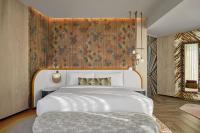 a bedroom with a large white bed with a floral wall at W Dubai - Mina Seyahi in Dubai