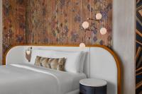 a white bed in a room with a wall at W Dubai - Mina Seyahi in Dubai
