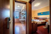 Postel nebo postele na pokoji v ubytování Hotel Sluníčko