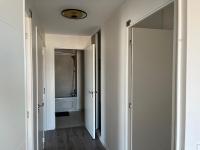 a hallway with a door leading to a bathroom at Appartement de Romainville in Romainville