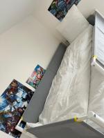 a bedroom with a bunk bed with comic books at Appartement de Romainville in Romainville