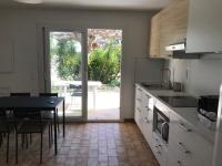 a kitchen with a table and a dining room at Vacances entre Bormes et Le Lavandou in Bormes-les-Mimosas