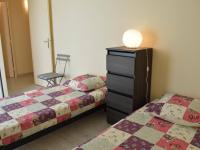 a bedroom with two beds and a dresser with a lamp at Appartement Le Grau-du-Roi, 3 pièces, 6 personnes - FR-1-250-61 in Le Grau-du-Roi