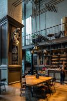 a restaurant with a table and chairs in a room at Conrad Shanghai in Shanghai
