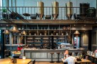 two people sitting at a bar in a restaurant at Conrad Shanghai in Shanghai