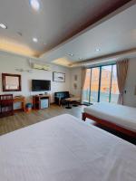 a hotel room with two beds and a flat screen tv at Blue Sea Inn in Eluan