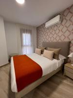 Postel nebo postele na pokoji v ubytování Apartamentos Doña Emilia