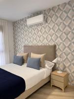 Postel nebo postele na pokoji v ubytování Apartamentos Doña Emilia