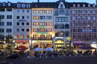 a group of buildings with people sitting in front of them at Hotel Schlicker in Munich