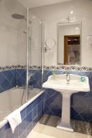 a bathroom with a sink and a shower and a tub at Auberge Saint Pierre in Le Mont Saint Michel