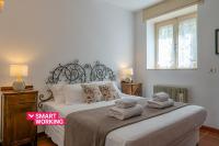 A bed or beds in a room at Swan Lake by Wonderful Italy