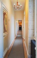 a long hallway with a chandelier and white walls at Domaine du Châtelard in Dirac