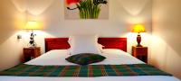 a bedroom with a bed with a green pillow on it at Domaine du Châtelard in Dirac