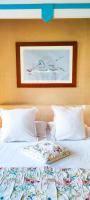a bed with white pillows and a painting on the wall at Domaine du Châtelard in Dirac