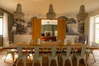 a dining room with a large wooden table and chairs at Mas des Coteaux - vue panoramique - piscine - babyfoot - pingpong - pétanque &amp; espace enfants à 1h de MONTAUBAN in Gramont