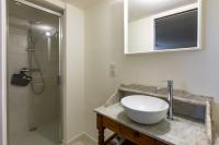 a bathroom with a white sink and a shower at Mas des Coteaux - vue panoramique - piscine - babyfoot - pingpong - pétanque &amp; espace enfants à 1h de MONTAUBAN in Gramont