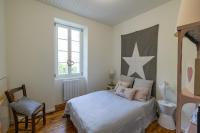 a bedroom with a bed and a star on the wall at Mas des Coteaux - vue panoramique - piscine - babyfoot - pingpong - pétanque &amp; espace enfants à 1h de MONTAUBAN in Gramont