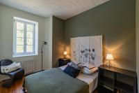 a bedroom with a bed and a chair and a window at Mas des Coteaux - vue panoramique - piscine - babyfoot - pingpong - pétanque &amp; espace enfants à 1h de MONTAUBAN in Gramont