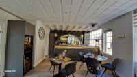a restaurant with two tables and chairs and a counter at HOTEL RESTAURANT NORMAND non étoilé ambiance familiale hotel de charme in Yport