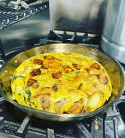 a pizza in a pan on top of an oven at The Historic Blue Moon Hotel - NYC in New York