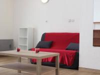 a living room with a red couch and a table at Appartement La Rochelle, 2 pièces, 4 personnes - FR-1-246-273 in La Rochelle