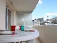 a white table with plates and glasses on a balcony at Appartement La Rochelle, 2 pièces, 4 personnes - FR-1-246-286 in La Rochelle