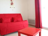 a red couch in a living room with a red table at Appartement La Rochelle, 2 pièces, 4 personnes - FR-1-246-286 in La Rochelle