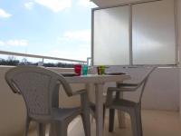 a table and two chairs sitting on a balcony at Appartement La Rochelle, 2 pièces, 4 personnes - FR-1-246-286 in La Rochelle