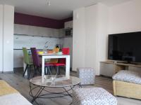 a living room with a table with chairs and a tv at Appartement La Rochelle, 3 pièces, 4 personnes - FR-1-246-588 in La Rochelle